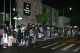 Bystanders watching by First Hawaiian Bank building as the Kaimuki Christmas Parade passes by