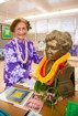 Julia McCullen placing a lei on the bust of Queen Lydia Lili`uokalani int he display room