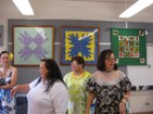 Former QLS staff: Pua Wilmington, Gwen Barcarse, and Karen Tsukiyama looking over the display room