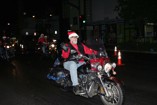 Santa rides a bike at the 2011 Kaimuki Christmas Parade
