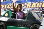 Waiving to Mom and Dad onboard The Speedway at Kaimuki Carnival 2016